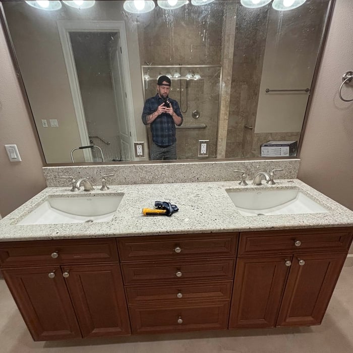 Double vanity with speckled granite countertop, undermount sinks and cherry cabinetry