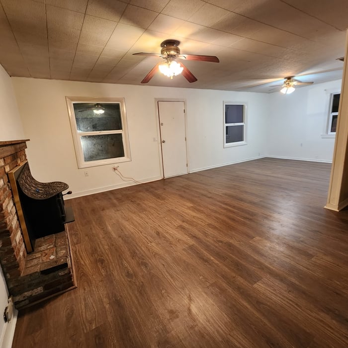 Reconstructed open living area with new windows, flooring and finished interior surfaces